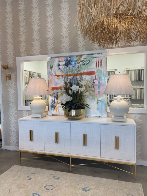 William white console with grass cloth paneling and gold leaf hardware