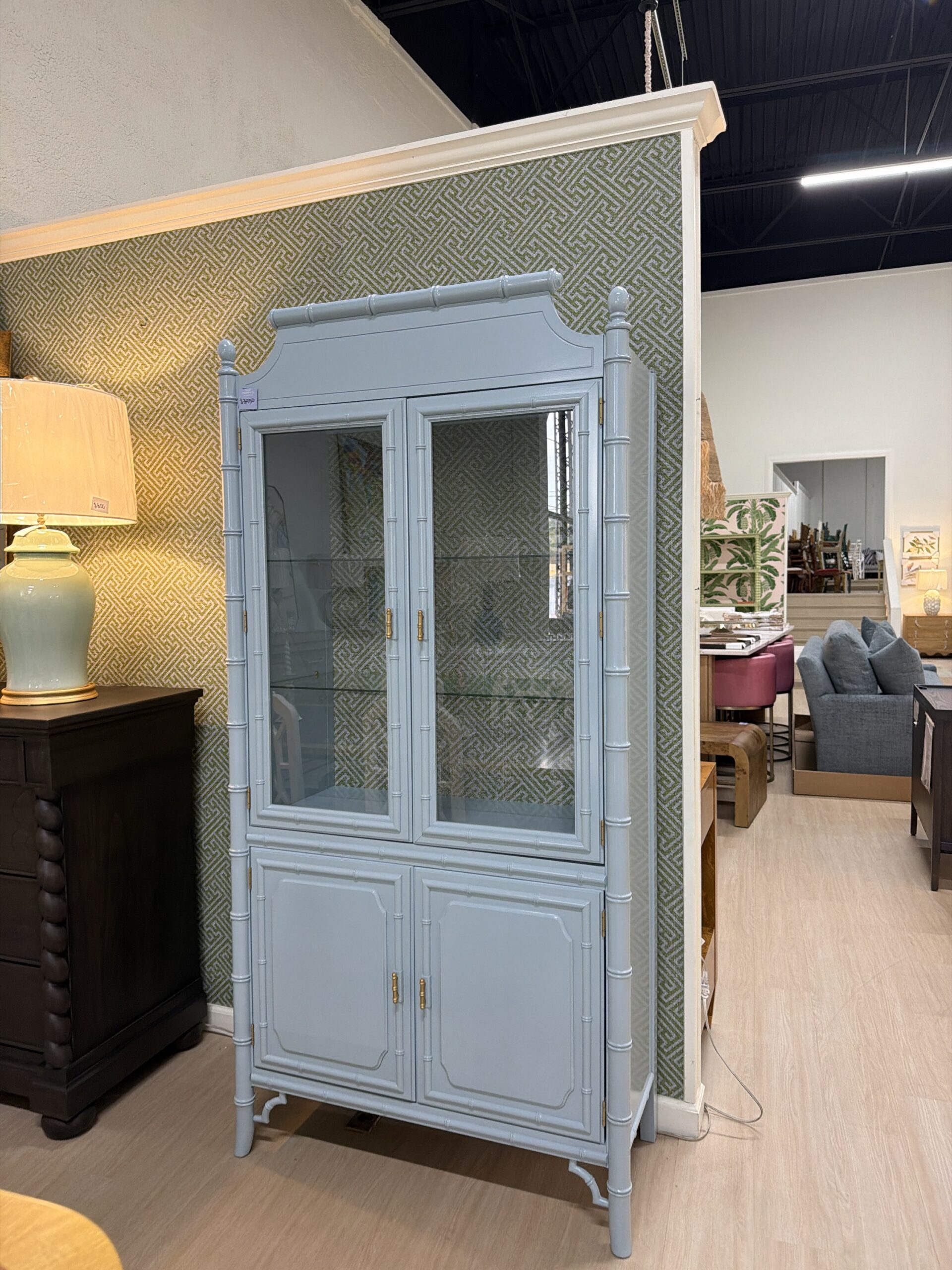Vintage lacquered China cabinet Dixie aloha with Thibaut wallpaper in the back and glass shelves