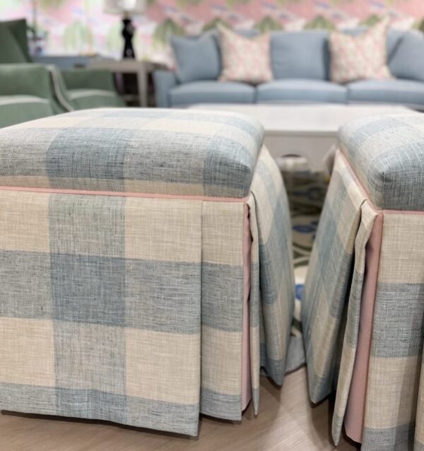 Set of blue buffalo check skirted Ottomans with a pink velvet welt