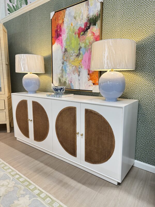 White four-door credenza with interior drawers, interior outlets, and Caine detailing