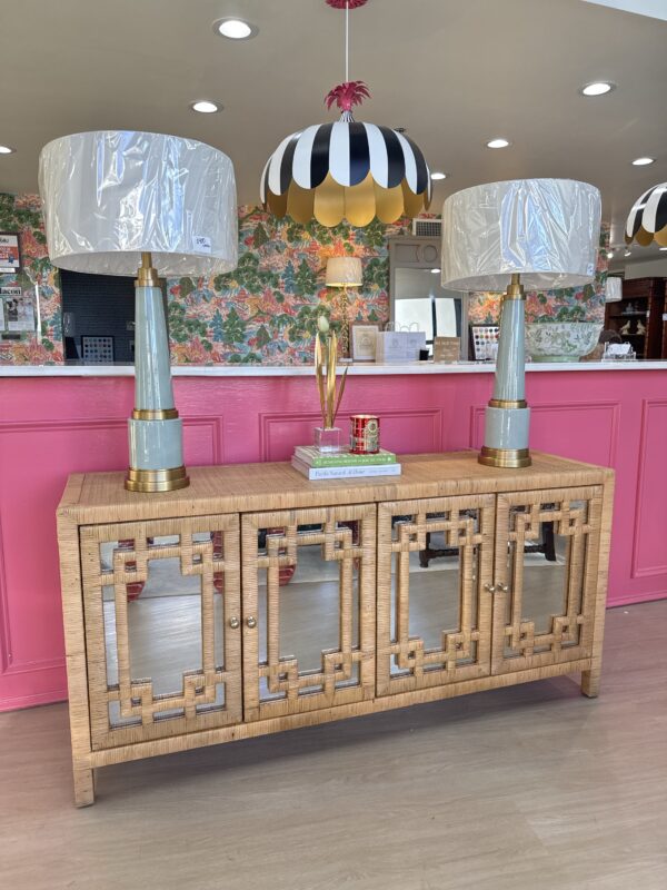 4 door media cabinet in rattan finished with mirror door fronts and gold knobs