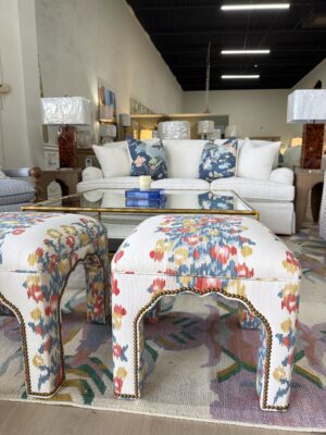 Ottoman set covered in primary floral fabric $1450 each and brass nail heads