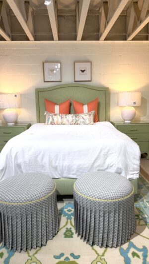 Sherrill Queen bed covered in spring green fabric with golden brass nail heads