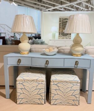 Light blue linnen curved console table with three drawers and gold hardware