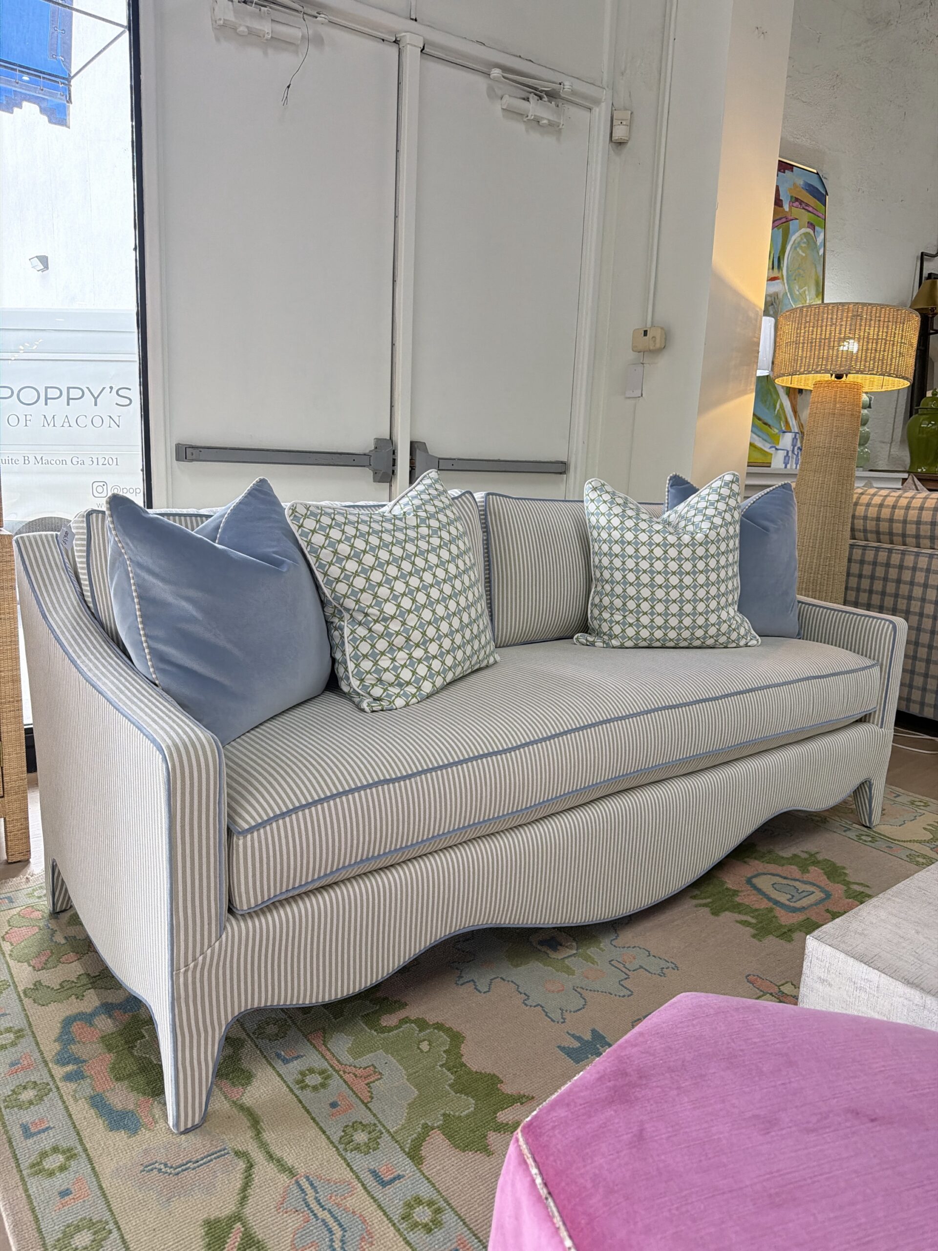Mila sofa covered in performance fabric sunbrella fern with blue welt